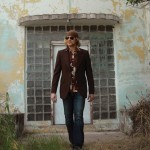 Photo of Michaux walking out of the entrance of an old building