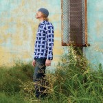 Photo of Michaux standing next to a window of an old building